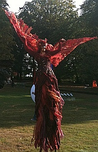 beautiful red stilt walker